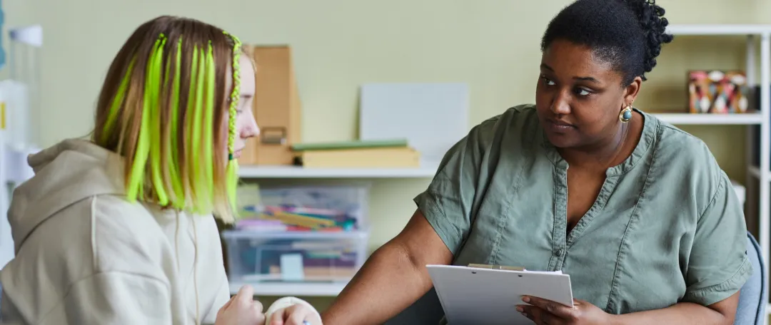 Teen with GP discussing mental health